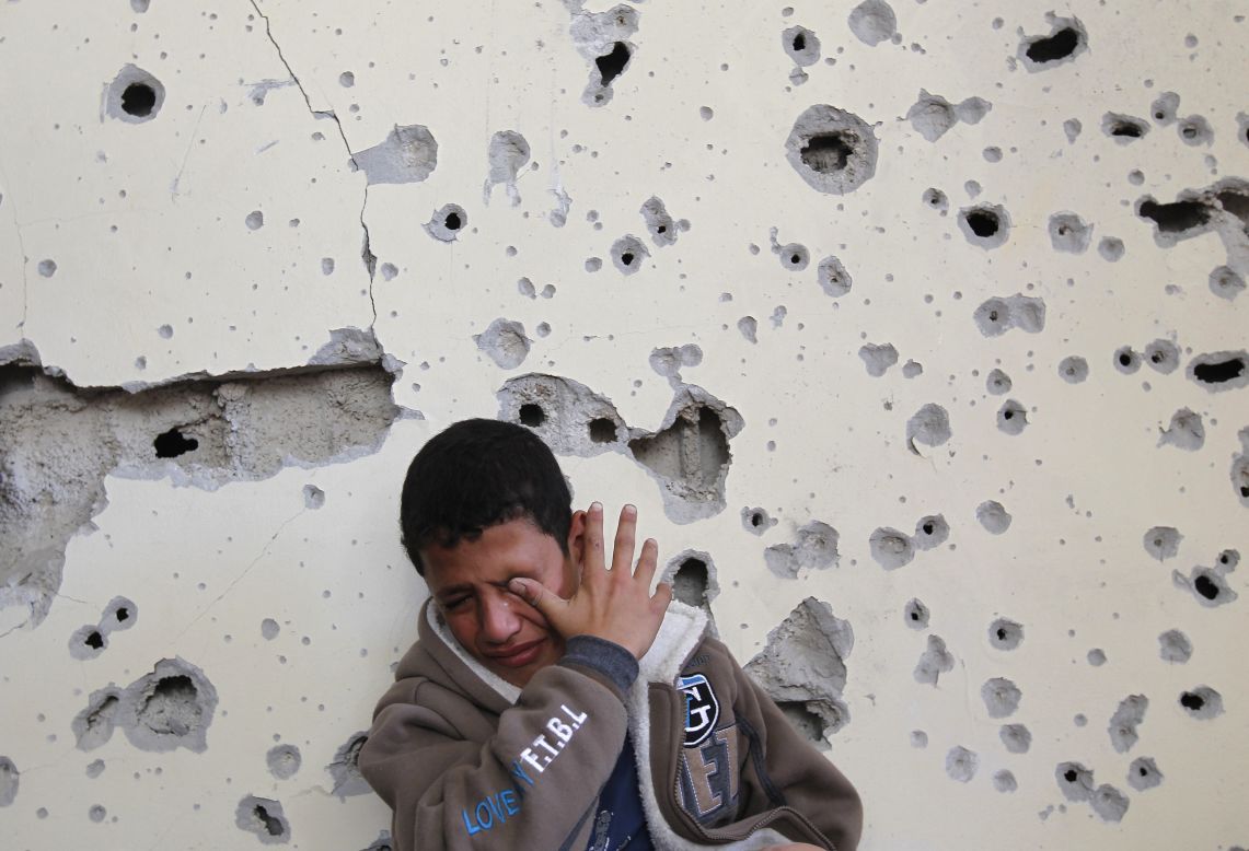 Palestinian Fares Sadallah, 11, cries outside his home after an Israeli airstrike Friday, November 16, in northern Gaza.