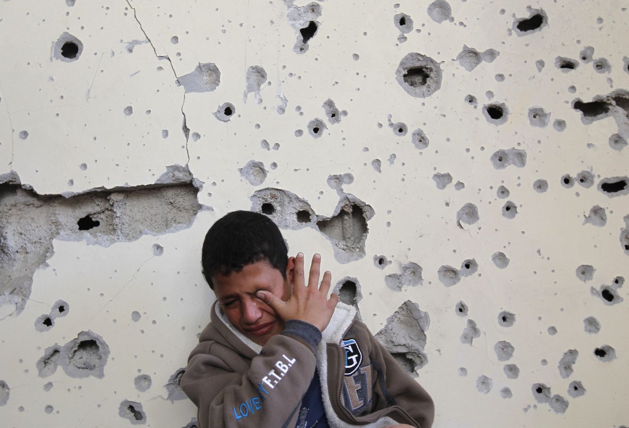 Palestinian Fares Sadallah, 11, cries outside his home after an Israeli airstrike Friday, November 16, in northern Gaza.