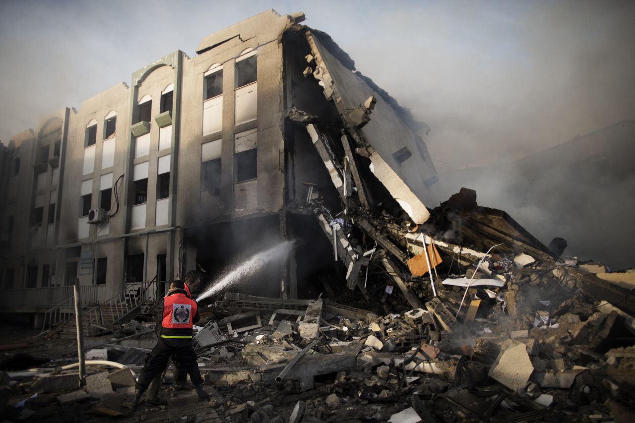 Palestinian firefighters try to extinguish a blaze Friday, November 16, at the Ministry of Interior in Gaza City following an Israeli air raid.