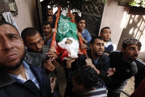 Palestinian mourners carry the body of Audi Naser during his funeral in Gaza on Friday, November 16.