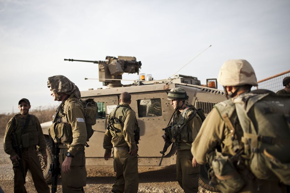 Israeli soldiers conduct a patrol as some 16,000 reserve troops are drafted in on Friday, November 16.