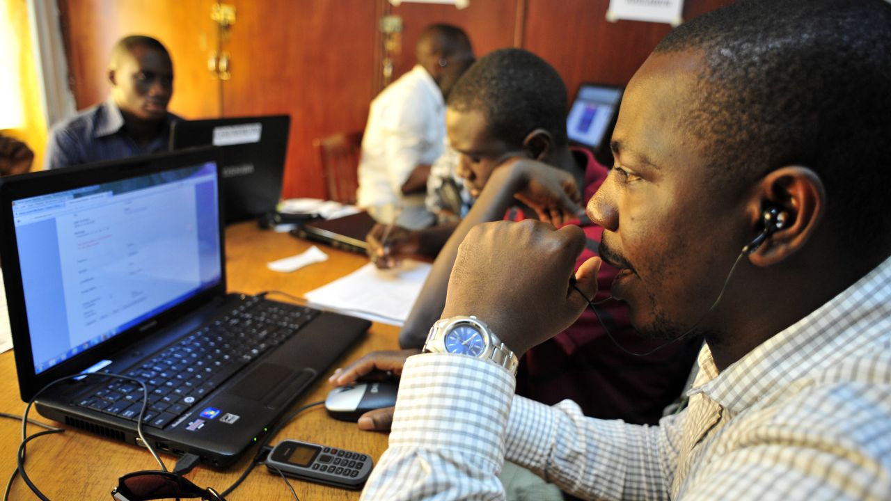 Observers for Sierra Leone's National Election Watch check computers in Freetown, November 16, 2012, ahead of elections.