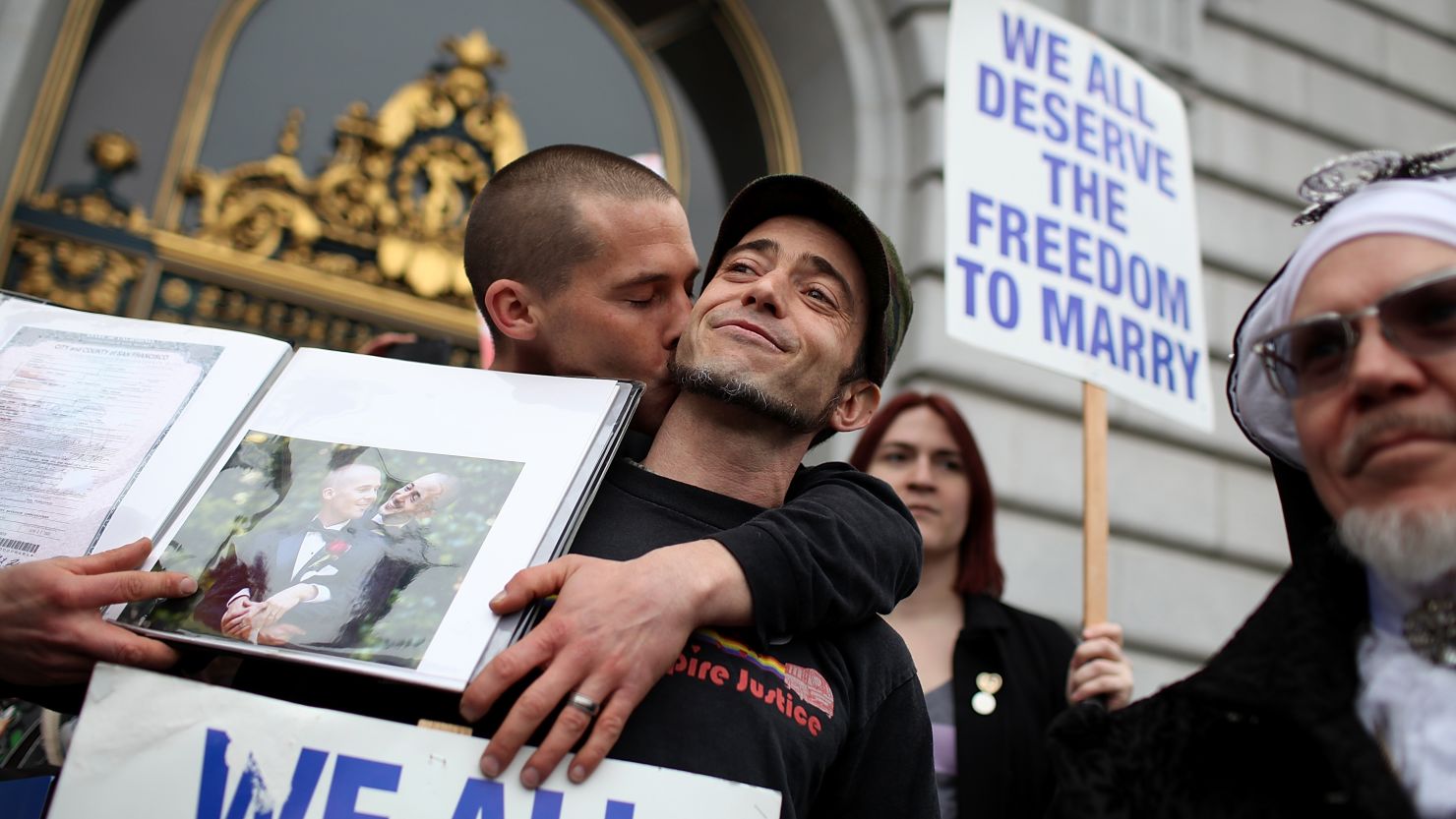 Same-sex couple Frank Capley-Alfano (L) and Joe Capley-Alfano kiss at City Hall in San Francisco, California, on February 7.