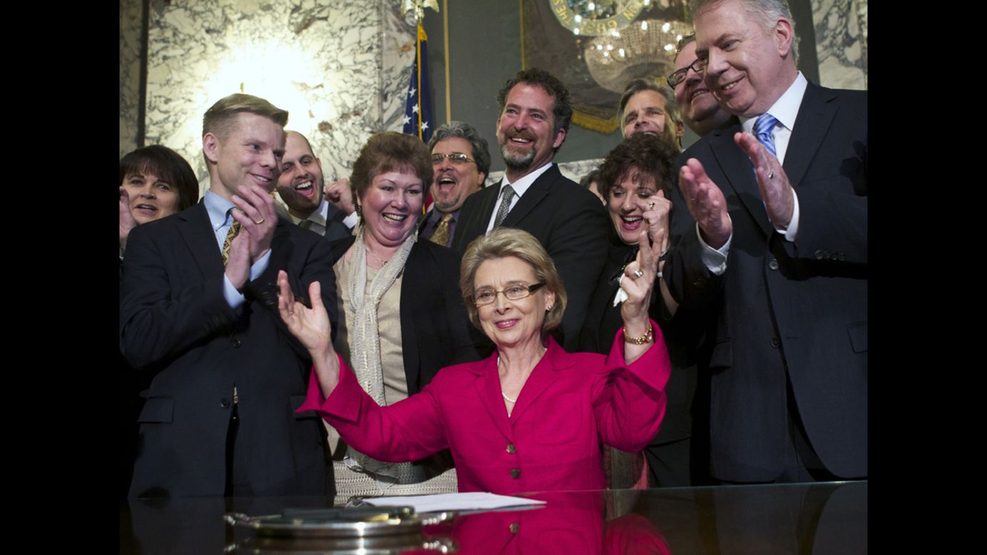 On February 13, 2012, Washington Gov. Chris Gregoire celebrates after signing marriage-equality legislation into law. Voters there approved same-sex marriage in November 2012, defeating a challenge by opponents.