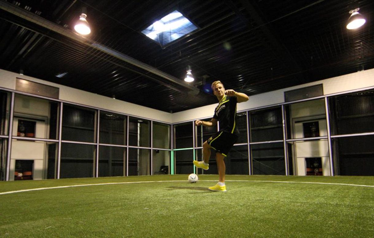 Once inside the "Footbonaut", a player is fed balls by eight different machines and then has deliver the ball to one of the 72 panels - - which is indciated by a flashing green light -- that make up the space-age contraption before they receive another ball. This picture shows Dortmund's German star Mario Gotze testing himself against the machine.