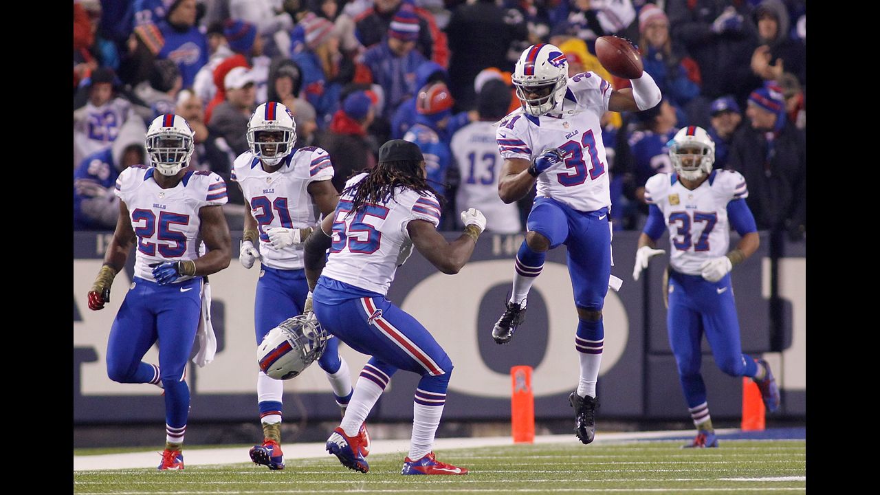 Jairus Byrd jumps in the air as his Buffalo Bills teammates celebrate his fourth-quarter interception against the Miami Dolphins at Ralph Wilson Stadium on Thursday, November 15, in Orchard Park, New York. Buffalo won the game 19-14. 