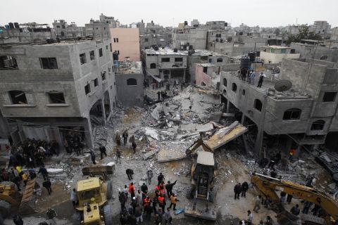 Palestinians gather at the site of an Israeli air raid in Gaza City on November 17, 2012. Israeli air strikes hit the cabinet headquarters of Gaza's Hamas government after militants fired rockets at Jerusalem and Tel Aviv as Israel called up thousands more reservists in readiness for a potential ground war.