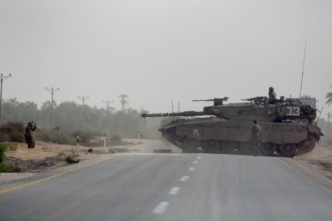 Israeli tanks maneuver at the Israeli-Gaza Strip border.