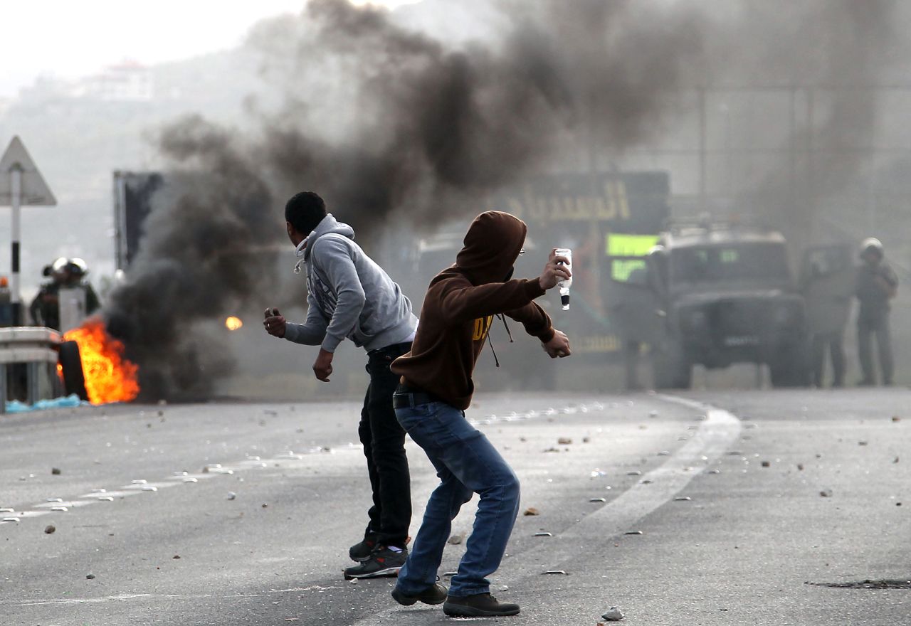 Palestinian youth clash with Israeli soldiers during protests at the Hawara checkpoin on Saturday, November 17.