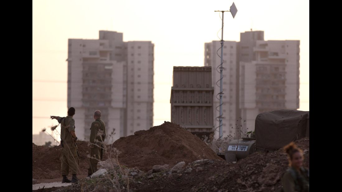 Israeli soldiers stand guard by the Iron Dome defense system launch site on Saturday, November 17, in Tel Aviv, Israel.