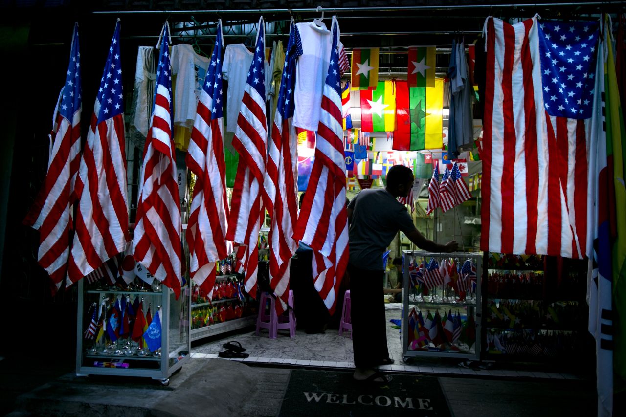 A Burmese worker is seen in a flag shop surrounded by American flags on Friday in Yangon.