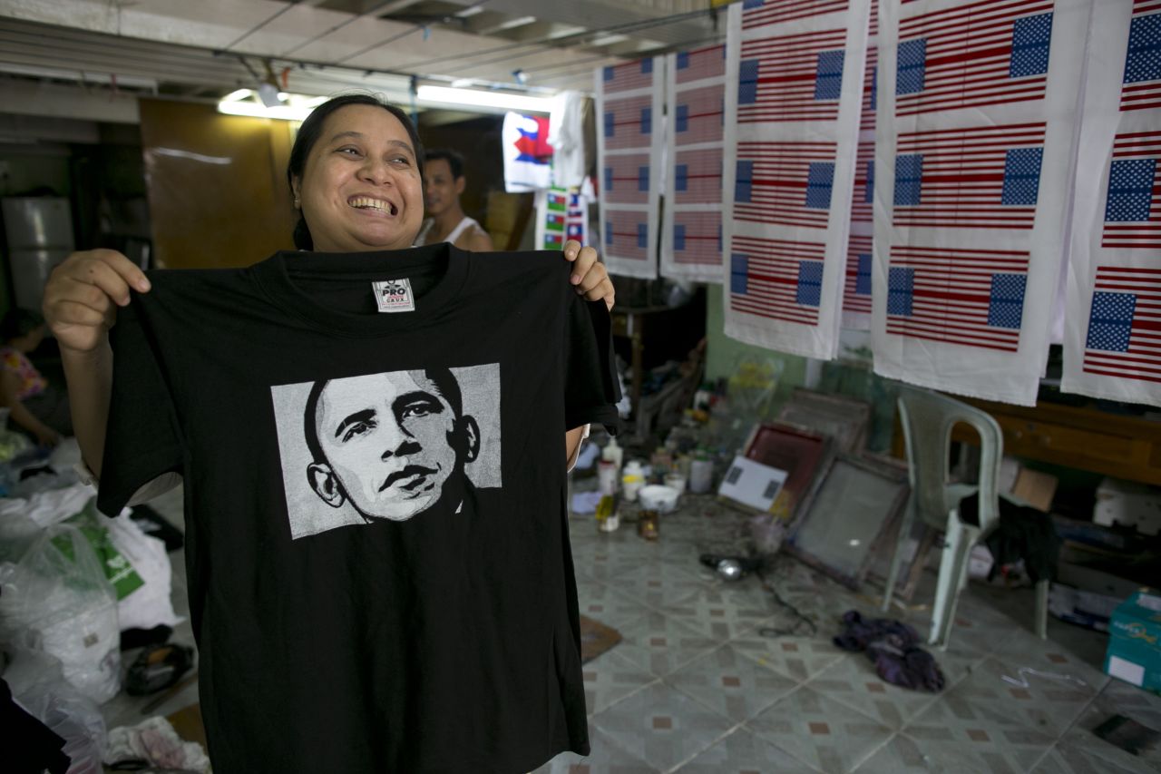 Kyu Kyu Mar, owner of Super silk screening shop, holds a T-shirt printed with an image of U.S. President Obama on Friday in Yangon.