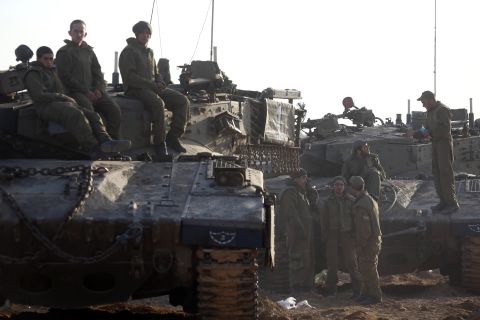 Israeli soldiers wait at an Israeli army deployment area near the Israel-Gaza Strip border on Sunday, November 18, as they prepare for a potential ground operation in the Palestinian coastal enclave. Israeli Prime Minister Benjamin Netanyahu said that Israel is ready to "significantly escalate" its operation against militants in the Hamas-run Gaza Strip.