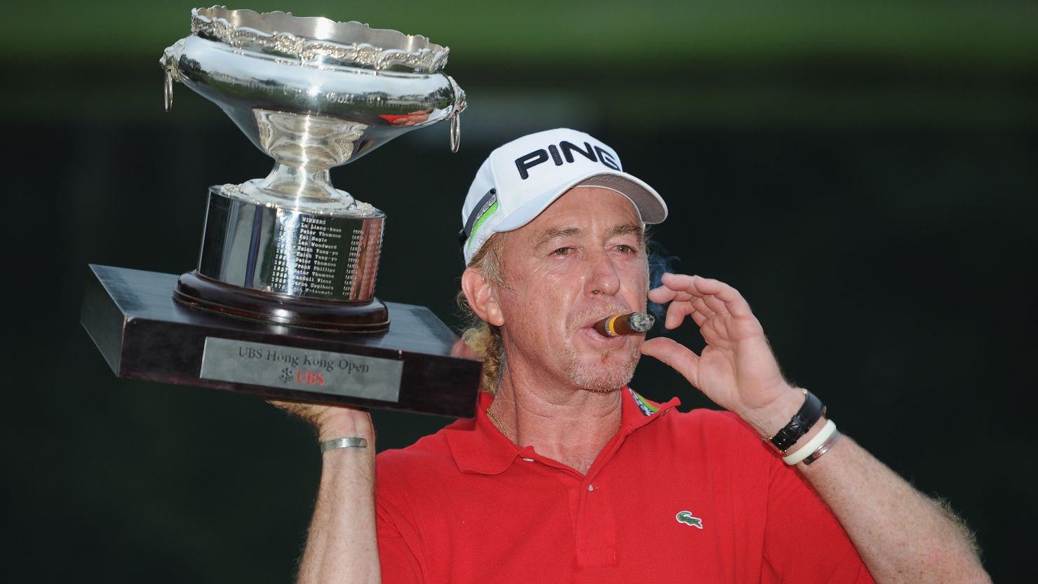 Miguel Angel Jimenez celebrates his victory in Hong Kong in familiar fashion, with a cigar and a glass of red wine