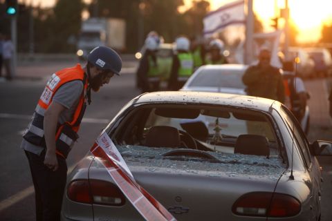 An Israeli emergency worker inspects the damage to a car in Ofakim, Israel, that was hit by a rocket fired by Palestinian militants from the Gaza Strip on Sunday, November 18.