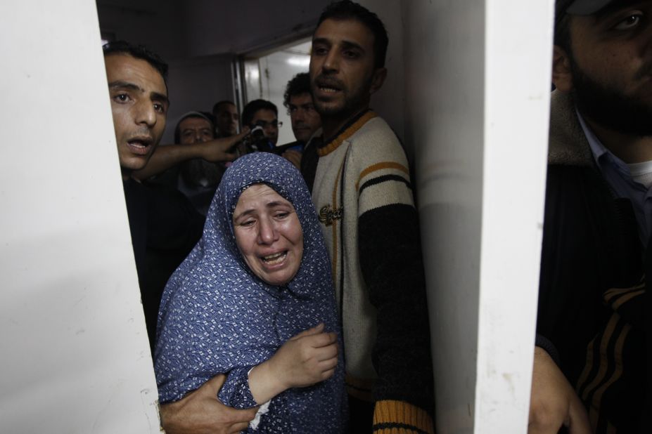 Palestinian relatives grieve at the hospital in Gaza City on Sunday, November 18, over family members killed in an airstrike.