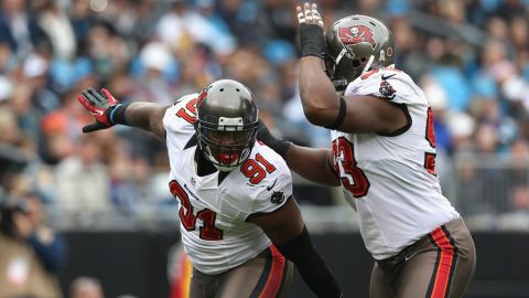 Tampa Bay Buccaneers Da'Quan Bowers, left, and Gerald McCoy celebrate after a sack during a game last season.