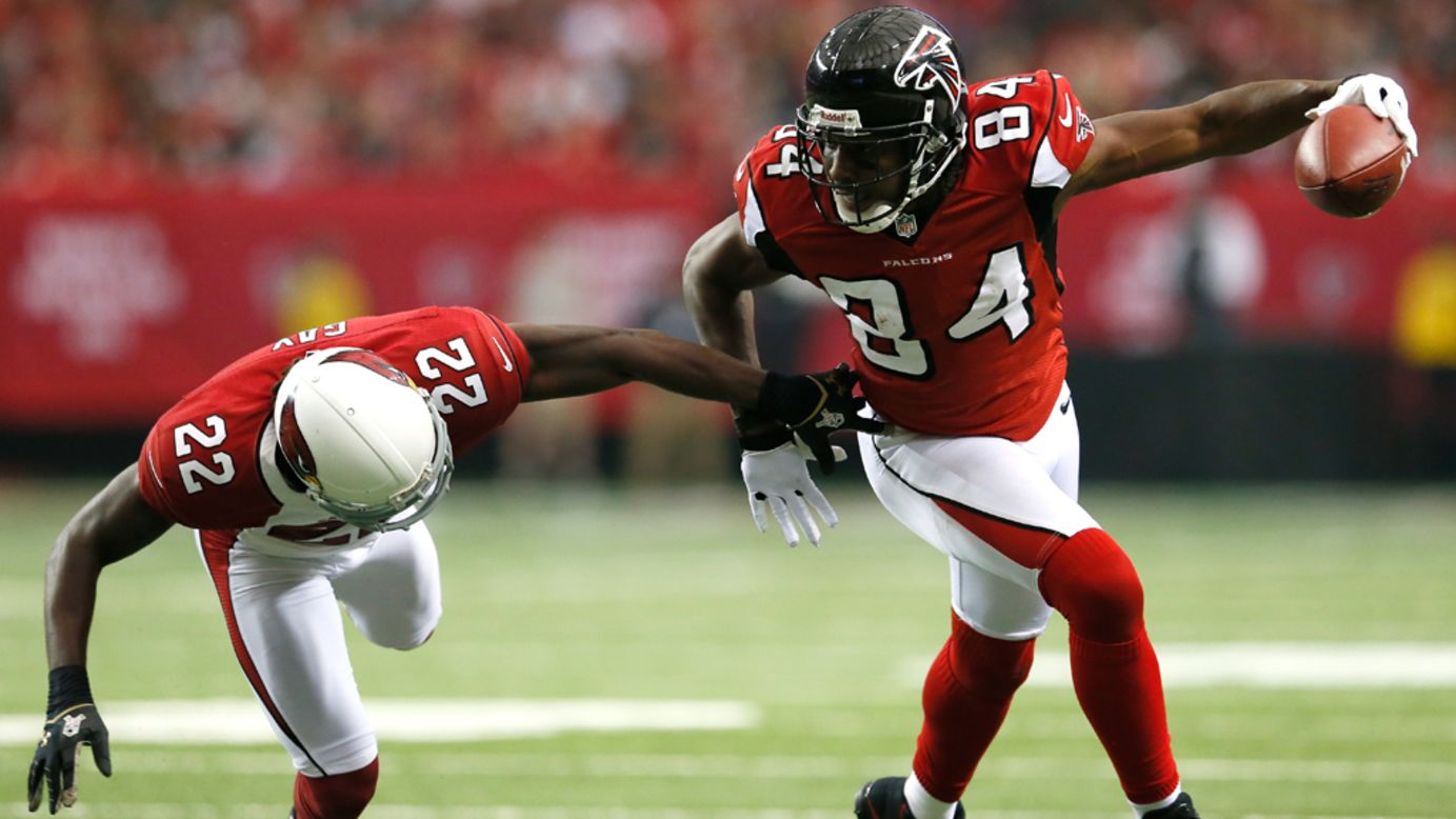 Roddy White of the Falcons breaks a tackle by William Gay of the Cardinals on Sunday.