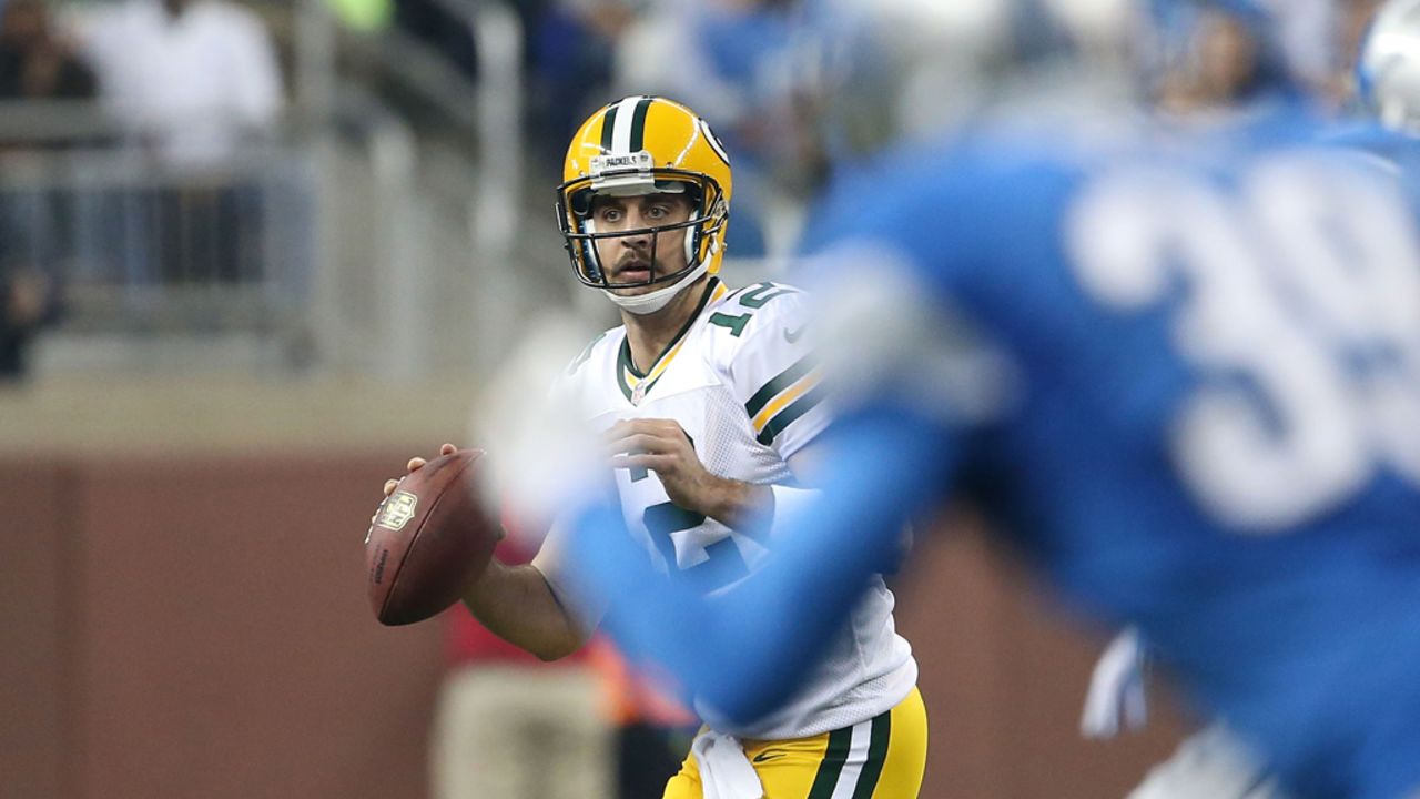 Aaron Rodgers of the Green Bay Packers rolls out to pass during the first quarter of the game against the Detroit Lions at Ford Field on Sunday in Detroit.