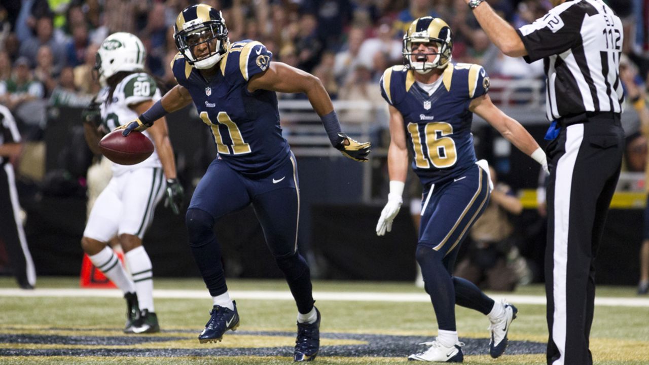 Wide receiver Brandon Gibson of the Rams prepares to throw the ball toward the crowd after catching a ball for a touchdown against the Jets on Sunday.