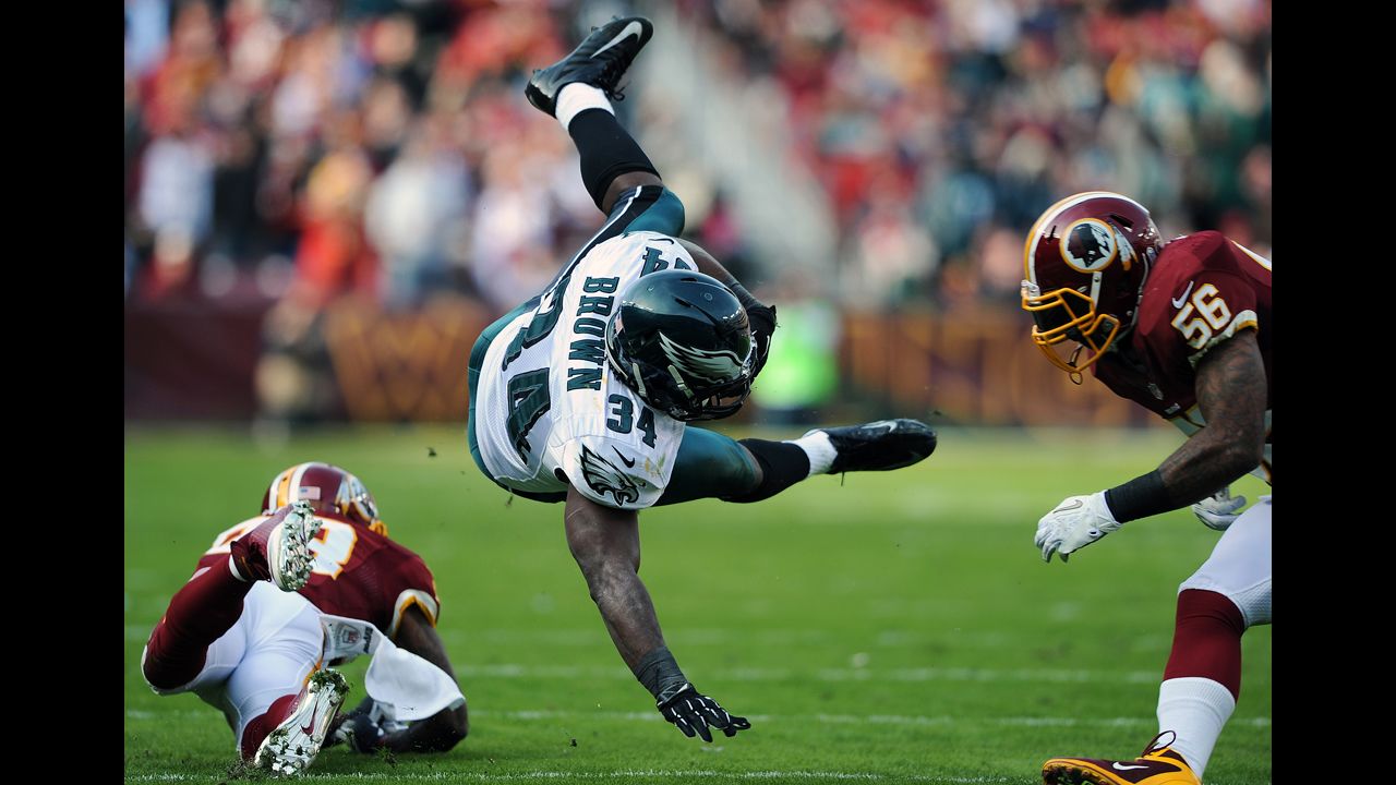 Running back Bryce Brown of the Eagles is upended by Redskins defenders in the second quarter on Sunday.