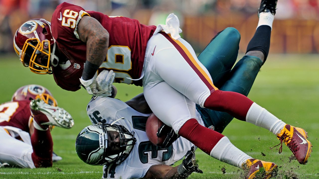 Running back Bryce Brown of the Eagles is hit by linebacker Perry Riley of the Redskins on Sunday.