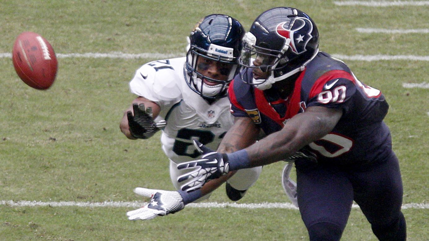 Andre Johnson of the Texans can't quite make the catch while Derek Cox of the Jaguars covers on the play on Sunday.