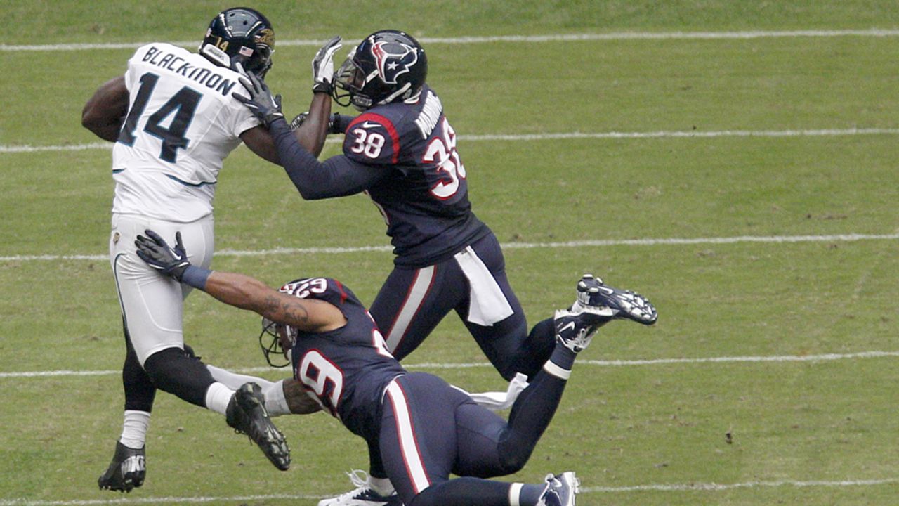 Justin Blackmon of the Jaguars tries to fend off No. 38 Danieal Manning of the Texans and No. 29 Glover Quin of the Texans on Sunday.