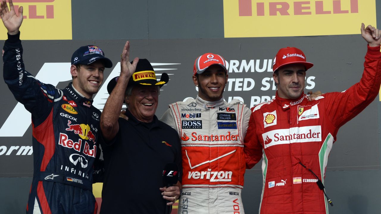 (L-R) Sebastian Vettel, former F1 champ Mario Andretti, Lewis Hamilton and Fernando Alonso on the podium in Texas