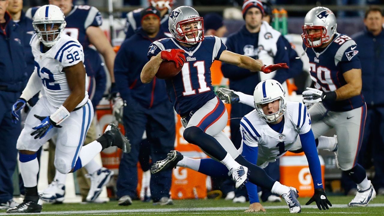 Julian Edelman of the Patriots avoids a tackle by Pat McAfee of the Colts while returning a punt for a touchdown against in the first half on Sunday.
