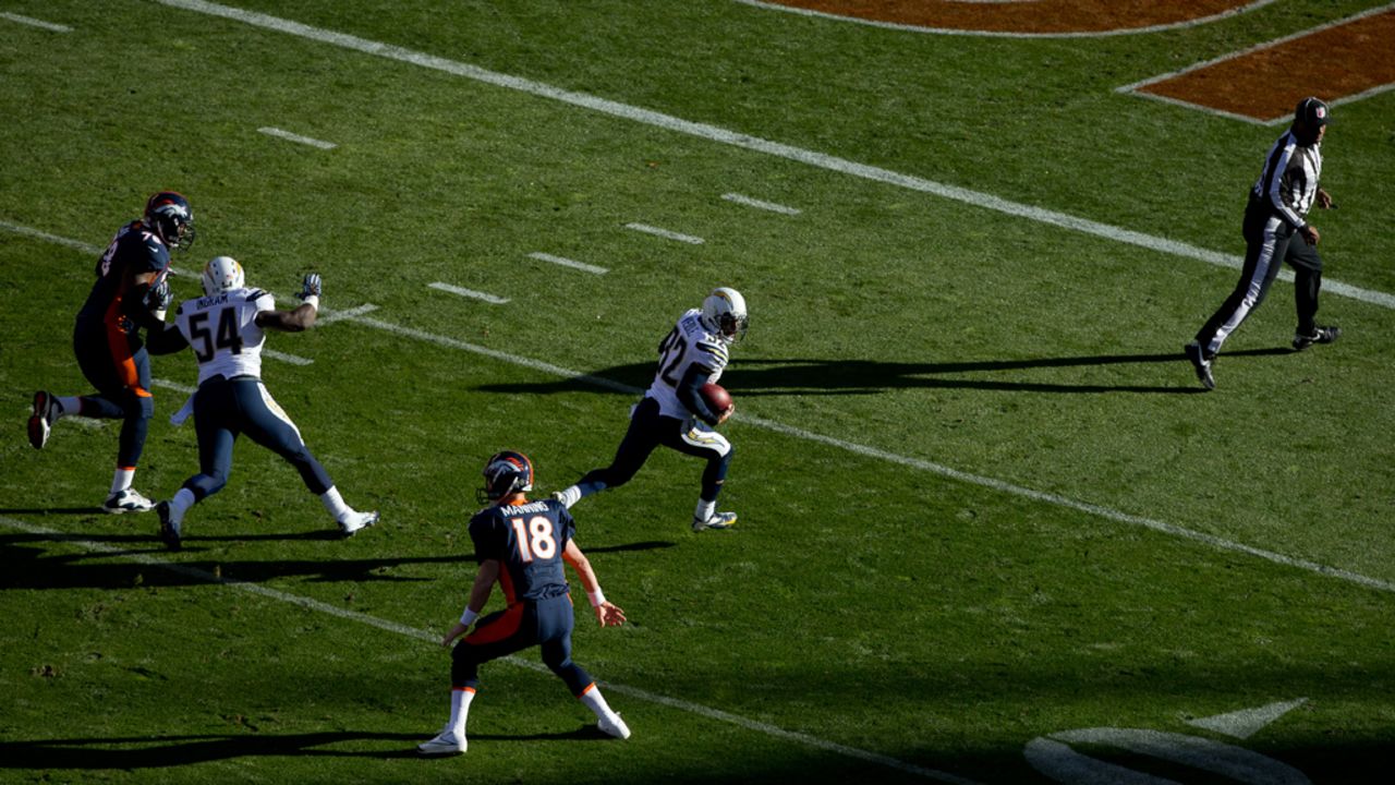 Safety Eric Weddle of the Chargers runs back an interception for a touchdown past quarterback Peyton Manning of the Broncos during the first quarter on Sunday.