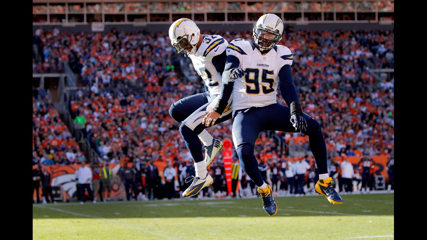No. 32 Eric Weddle of the Chargers celebrates his 23-yard interception for a touchdown with No. 95 Shaun Phillips of the Chargers against the Broncos in the first quarter on Sunday.
