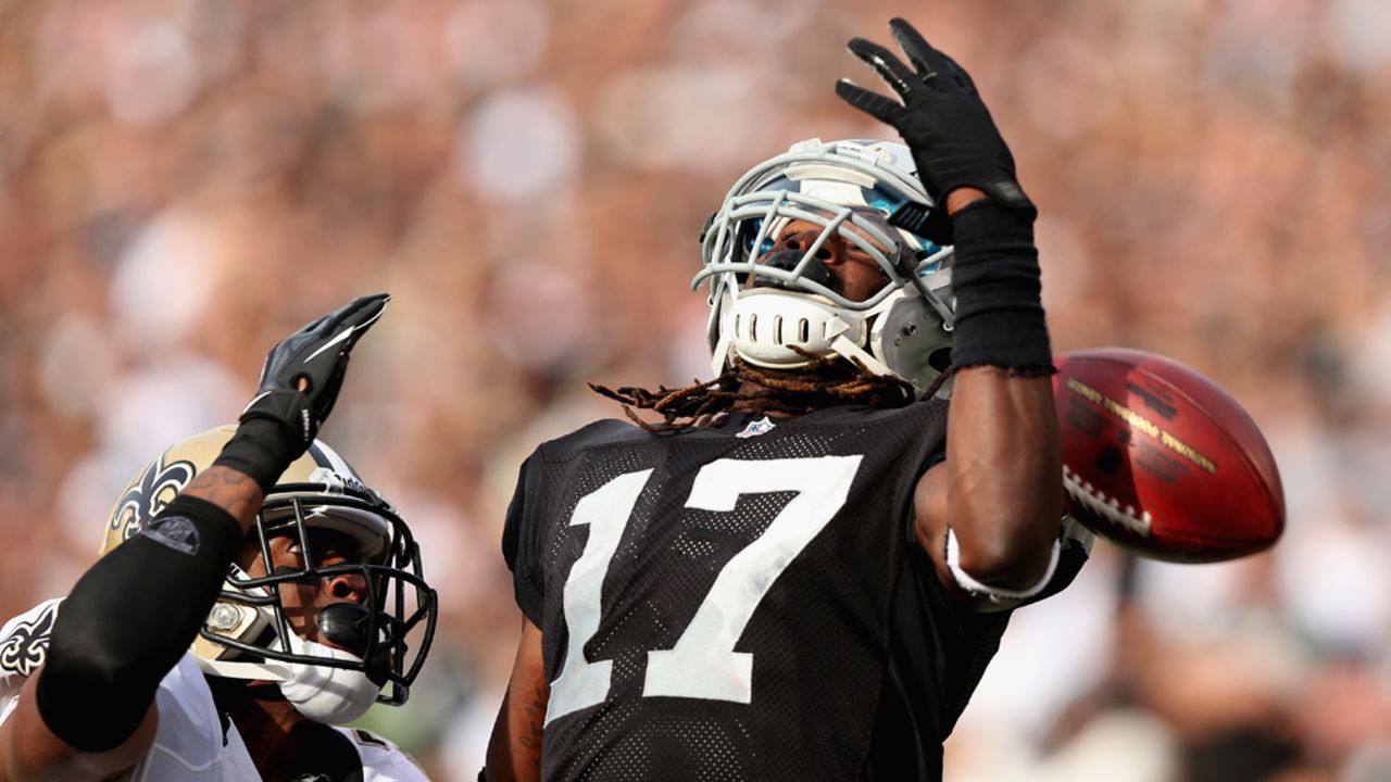 Denarius Moore of the Raiders cannot catch a pass while defended by Patrick Robinson of the Saints on Sunday.