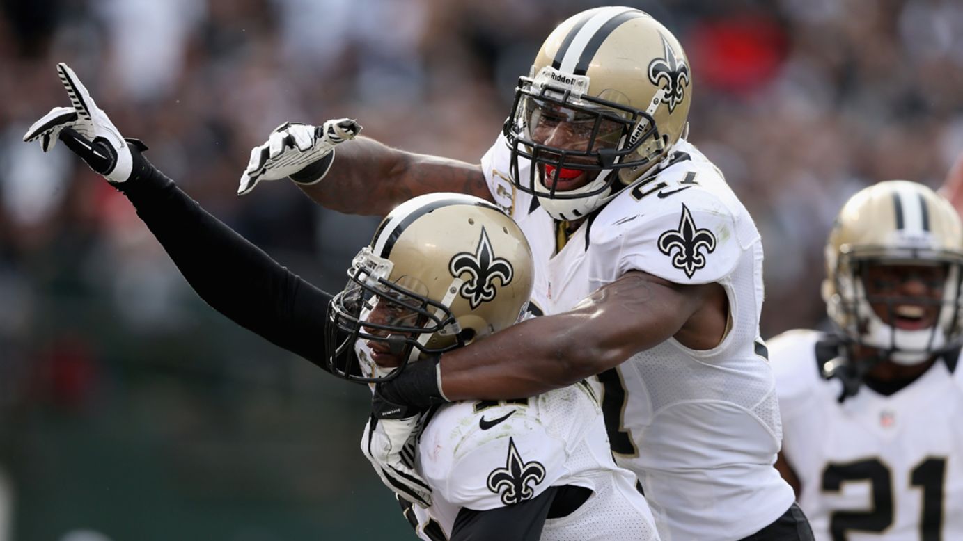 Roman Harper of the Saints is congratulated by Malcolm Jenkins after Harper intercepted the ball in the endzone during their game on Sunday.