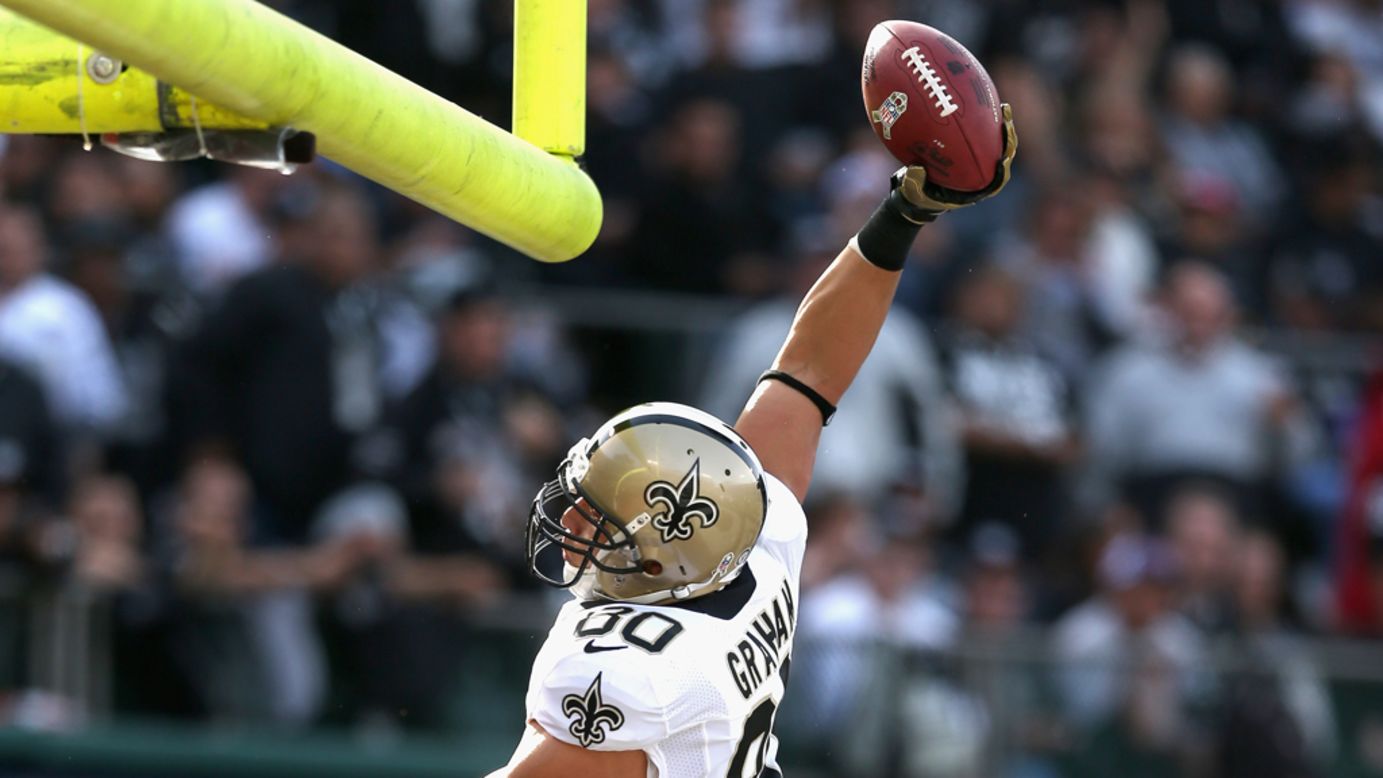 Jimmy Graham of the Saints dunks the ball over the goal posts after he scored a touchdown against the Raiders on Sunday.