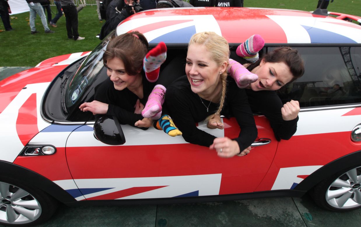 Linsi Ludlam, from left, Helen Statnic and Katie Fitzpatrick are part of the 28-member team from the UK who dared to set a world record for how many people can fit in a modern Mini hatchback -- which they did.