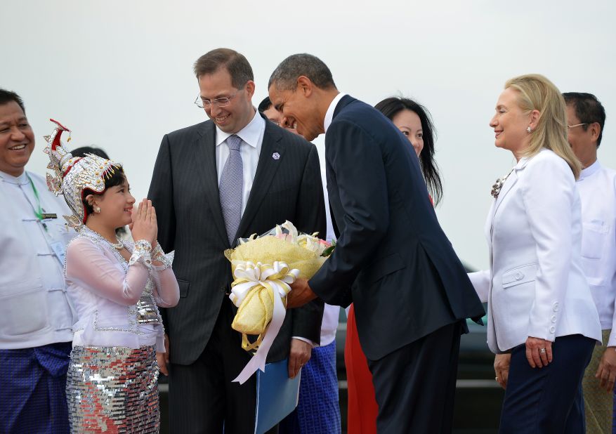 U.S. President Obama is greeted by a local woman as he arrives with U.S. Secretary of State Hillary Clinton in Yangon, Myanmar, on Monday.
