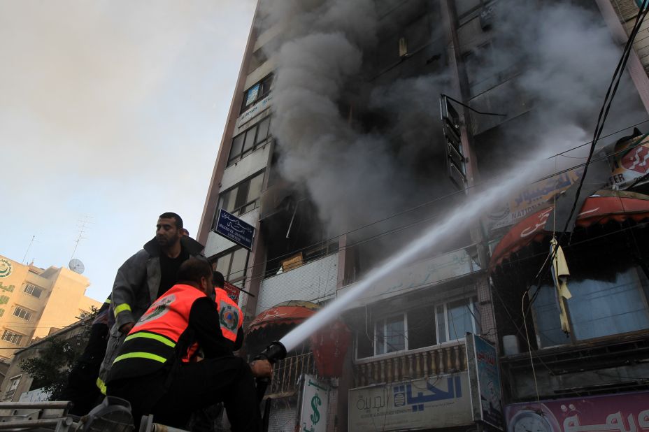 Palestinian firefighters extinguish a blaze following an Israeli airstrike in a Gaza City tower housing Palestinian and international media on Monday.