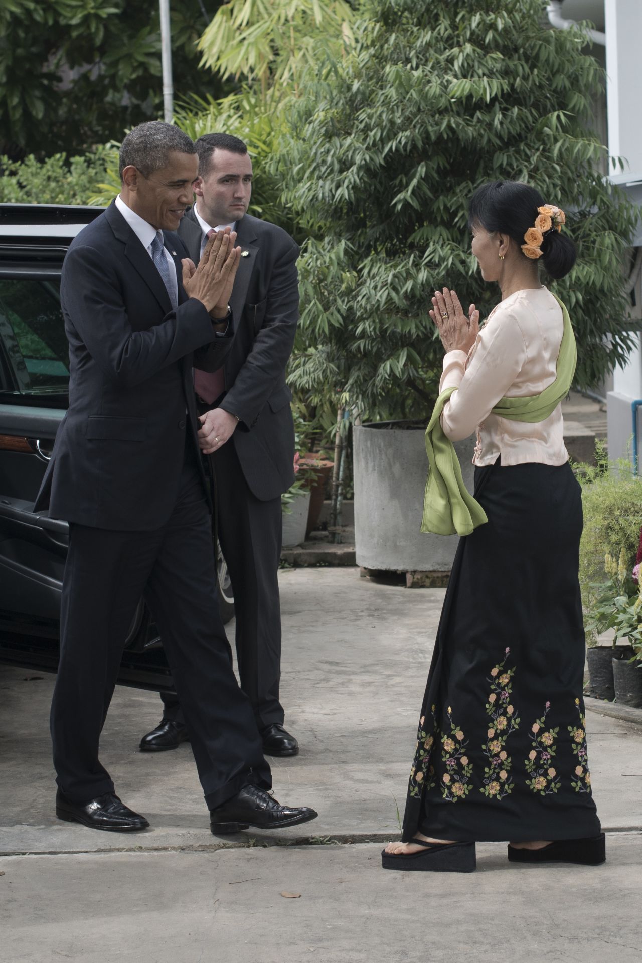 U.S. President Obama  is greeted by Myanmar pro-democracy leader Aung San Suu Kyi at her residence in Yangon on Monday.