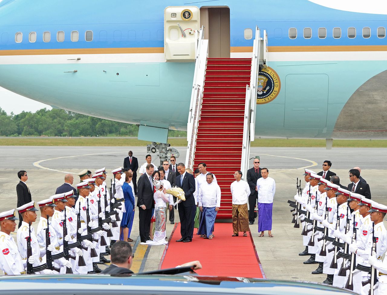 U.S. President Obama is greeted by a contingent at the Yangon International airport on Monday.