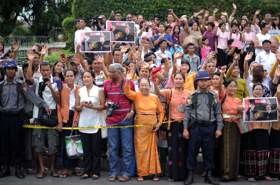 Local residents gather outside Aung San Suu Kyi's house as U.S. President Obama met with her on Monday. 
