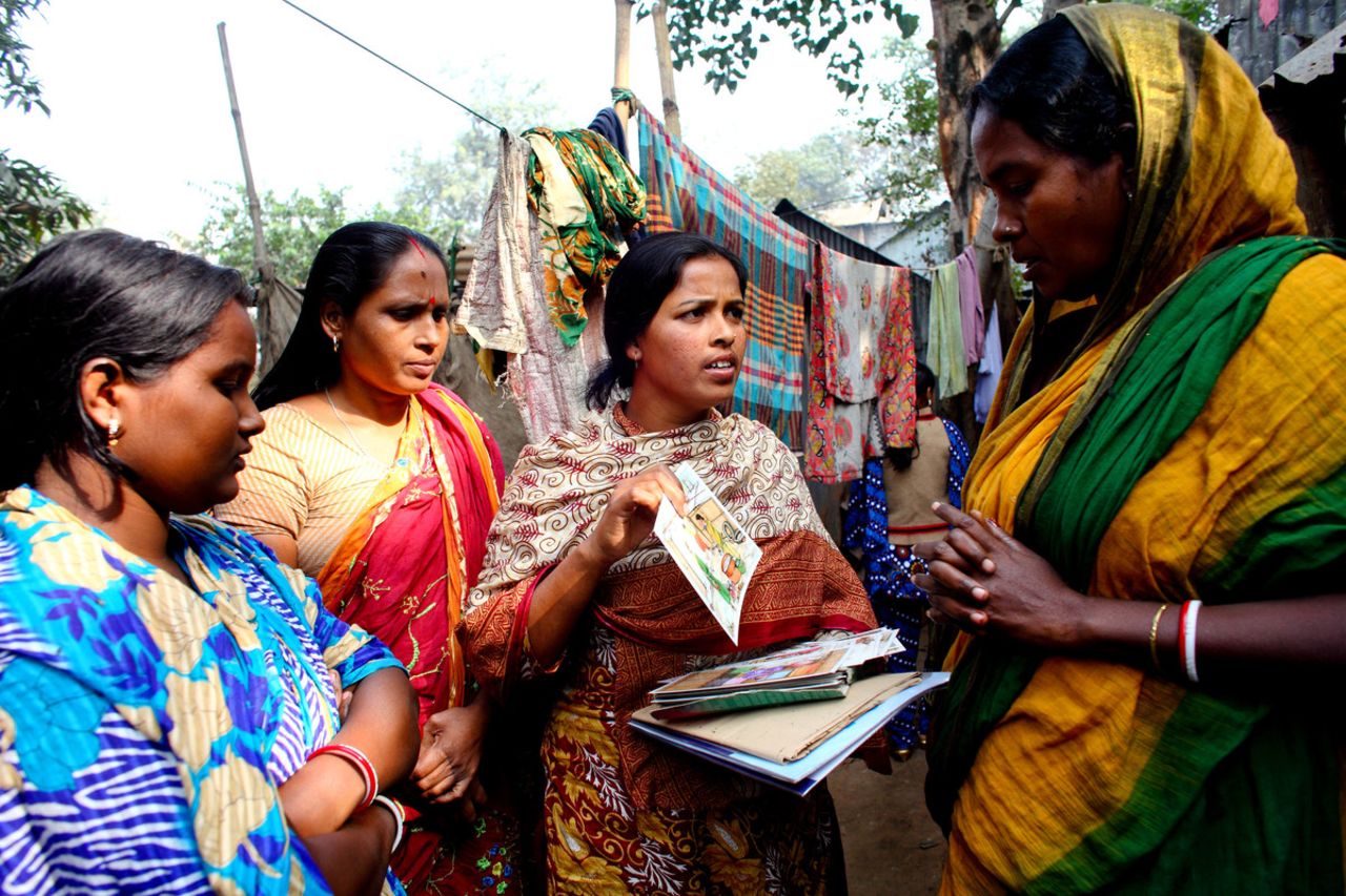 Shamola Rani Mondol (center) in Dhaka, Bangladesh, is a local WASH committee member. All nine members of the committee are women who teach others in the community about hygiene. She says: "The men respect us more now. Nowadays when we go anywhere the men give us seats with honor and they say that the women are able to do lots of things. Now the men are happy with the women's work."