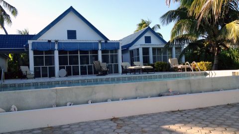 John McAfee shares his home in Belize with seven girlfriends, two women told CNN.