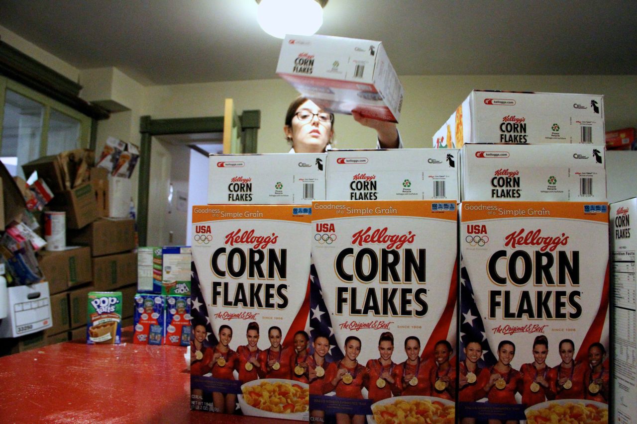 A volunteer stacks cereal donated by Kellogg's and the U.S. women's Olympic gymnastics team to storm victims.