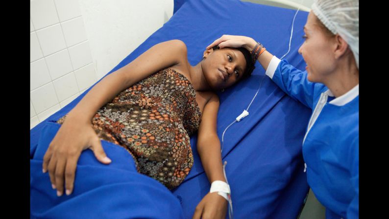 Escobar comforts a woman in labor at a maternity clinic she established in Cartagena. Escobar said she started her foundation after seeing too many babies die from preventable causes.