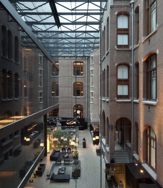 The vast enterance lobby of the Conservatorium hotel in Amsterdam. The building also features a library and indoor garden.