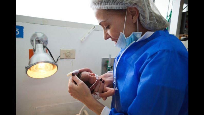 Escobar holds a baby at the maternity clinic in Cartagena. She named her foundation for her 16-month-old son, Juan Felipe, who died in 2000 when he accidentally fell from the balcony of her home.