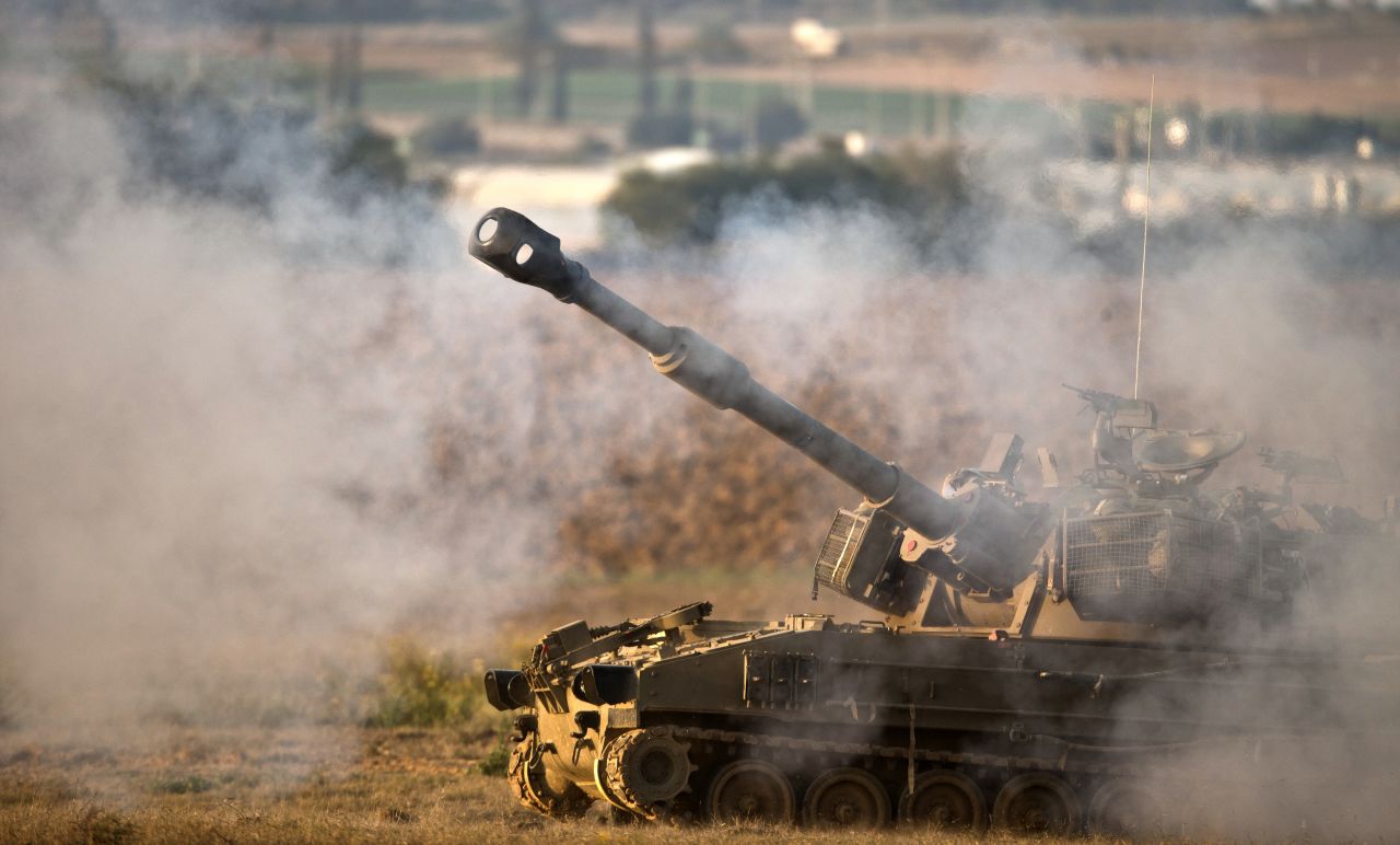 Israeli forces fire a shell from the Israel-Gaza border into Gaza on Tuesday.