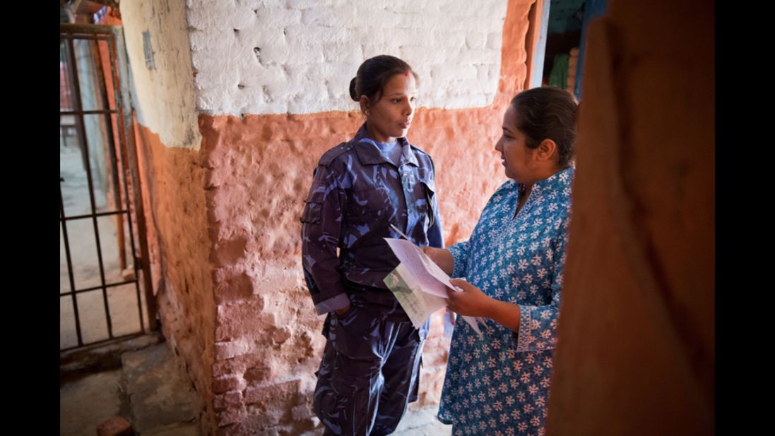 Basnet talks to a female prison guard to gain permission to go inside a jail in Kathmandu. Basnet was studying social work in college when she first visited a women's prison and discovered how many children had to live there.