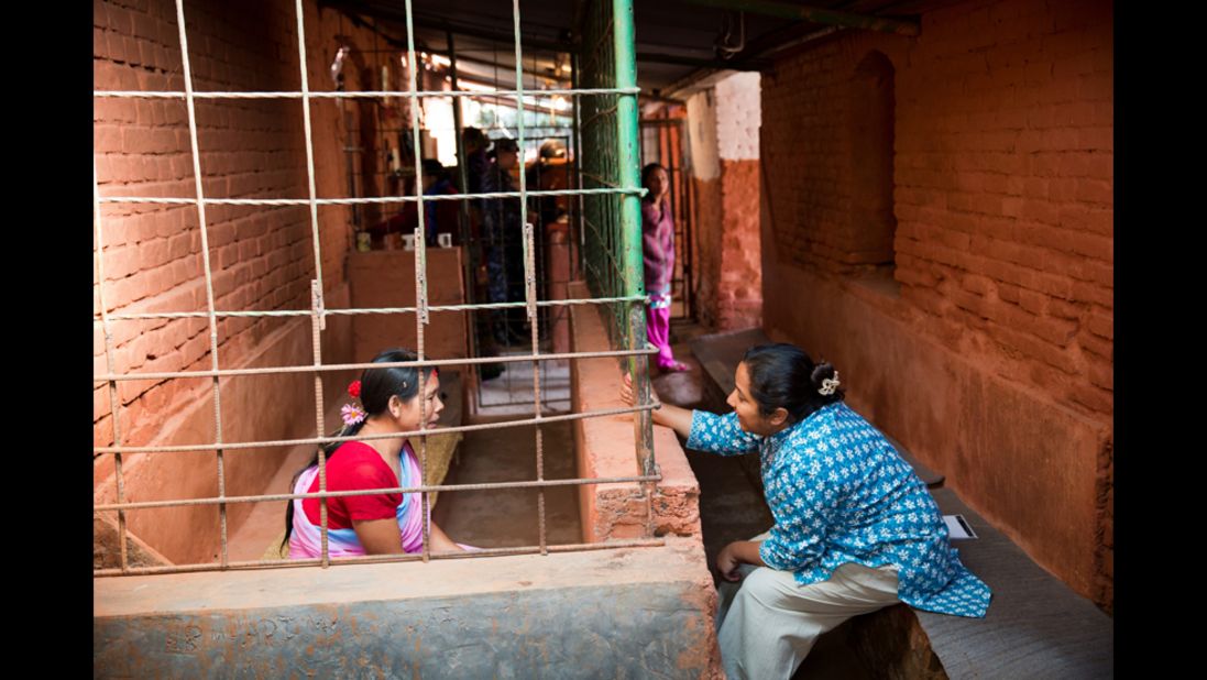 Basnet talks to an inmate in Kathmandu. "Meeting and spending time with the children and the mothers in jail, you realize that Pushpa is their only hope," said photographer Palani Mohan.